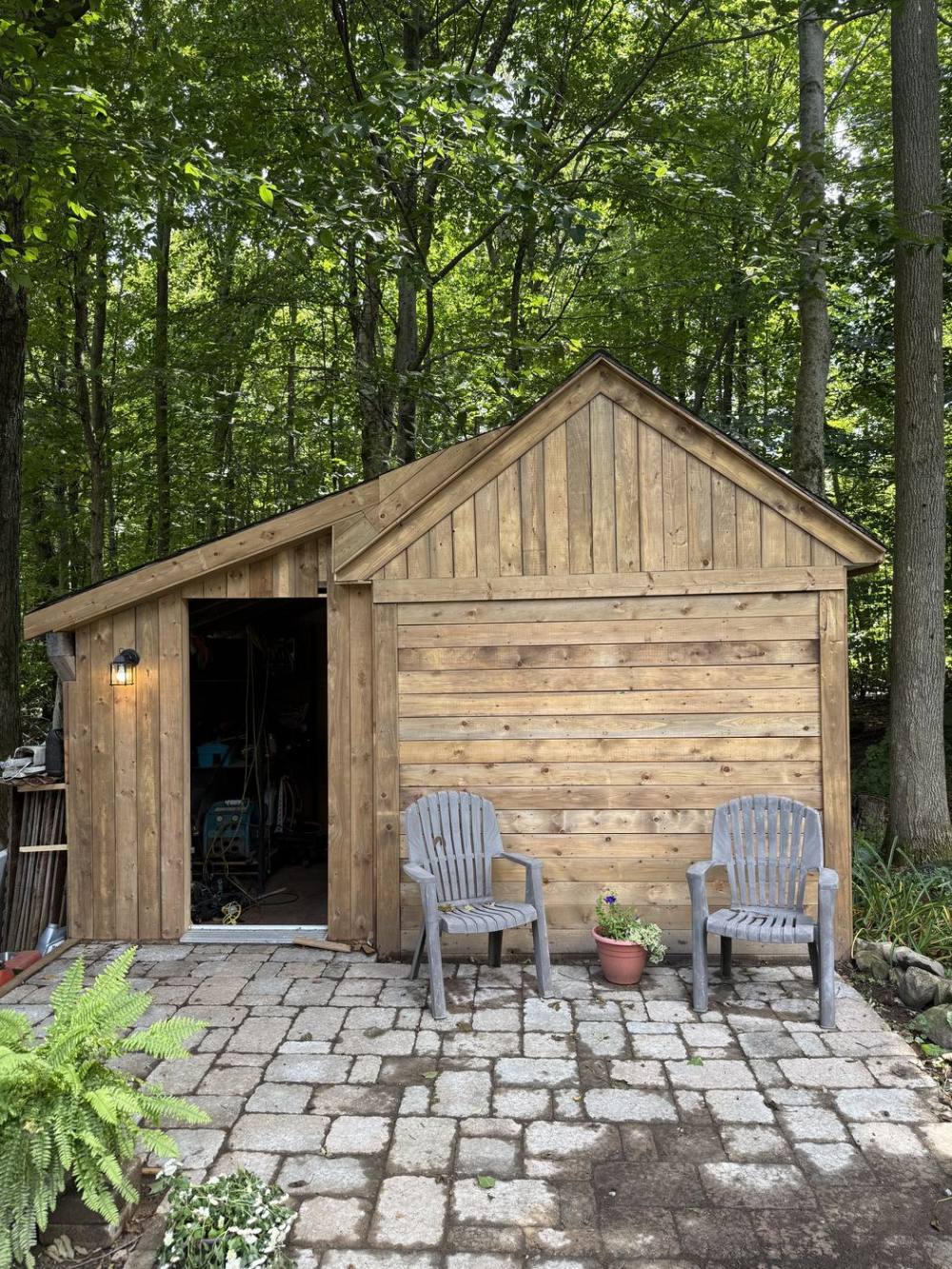 Custom wood-frame storage shed with cedar siding built by Tandem Projects